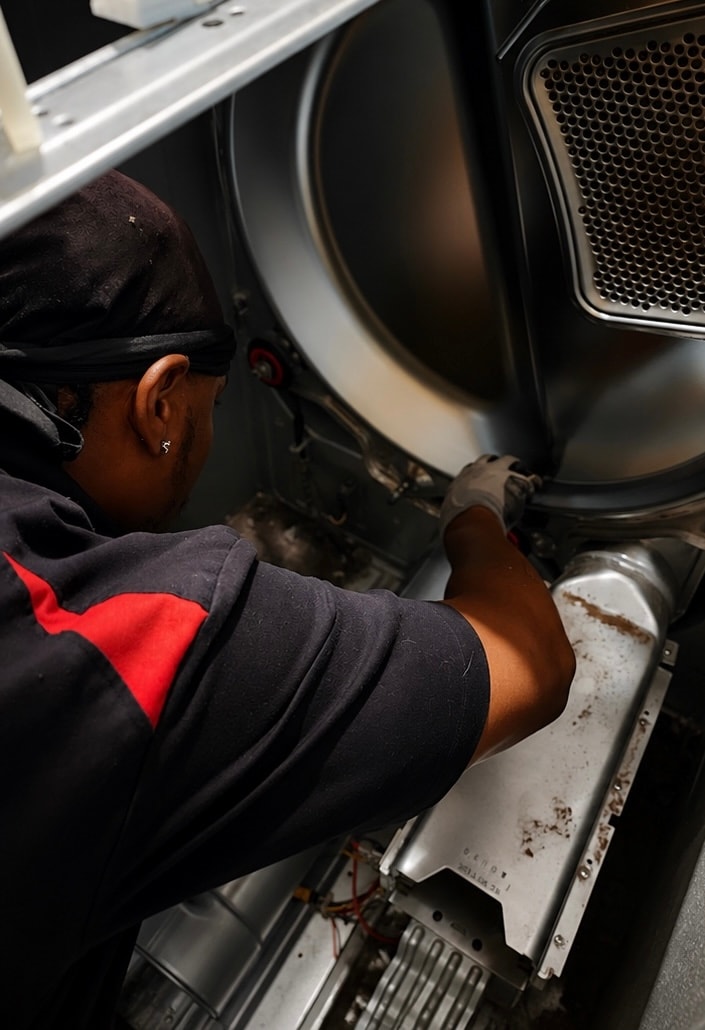Technician repairing a dryer