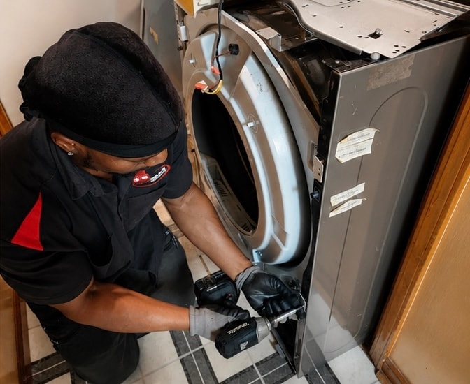 Technician repairing a washer